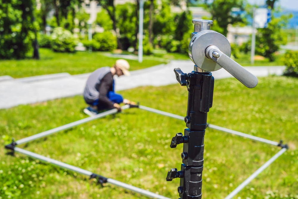 technician adjusting underground irrigation system in a Dallas yard